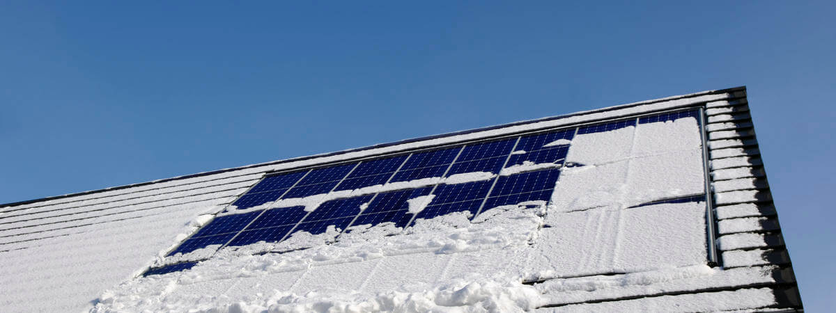 Snow covered solar panels on the roof